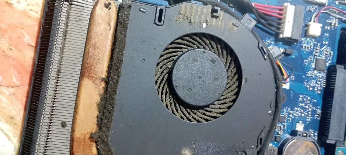 Dell laptop fan full of dust and debris before professional cleaning