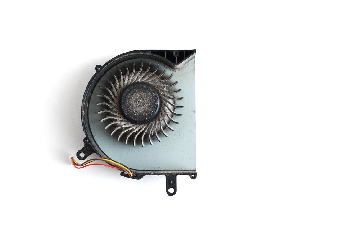 Dirty dust on laptop computer cooling fan before cleaning and maintenance