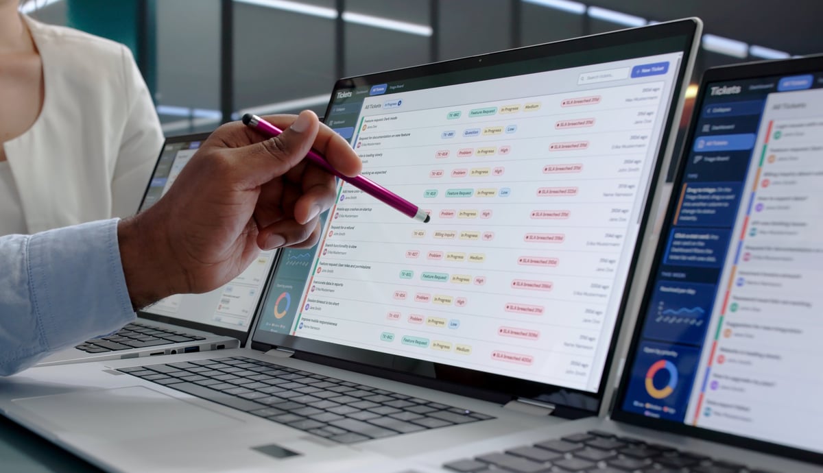 Young IT Support Professional Resolves Customer Issues Using Laptop And Software Tools.
